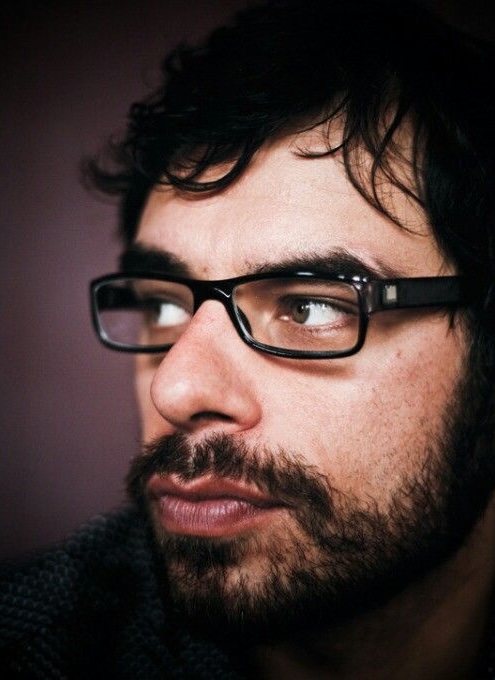 Jemaine Clement: headshot of a man with a beard and glasses